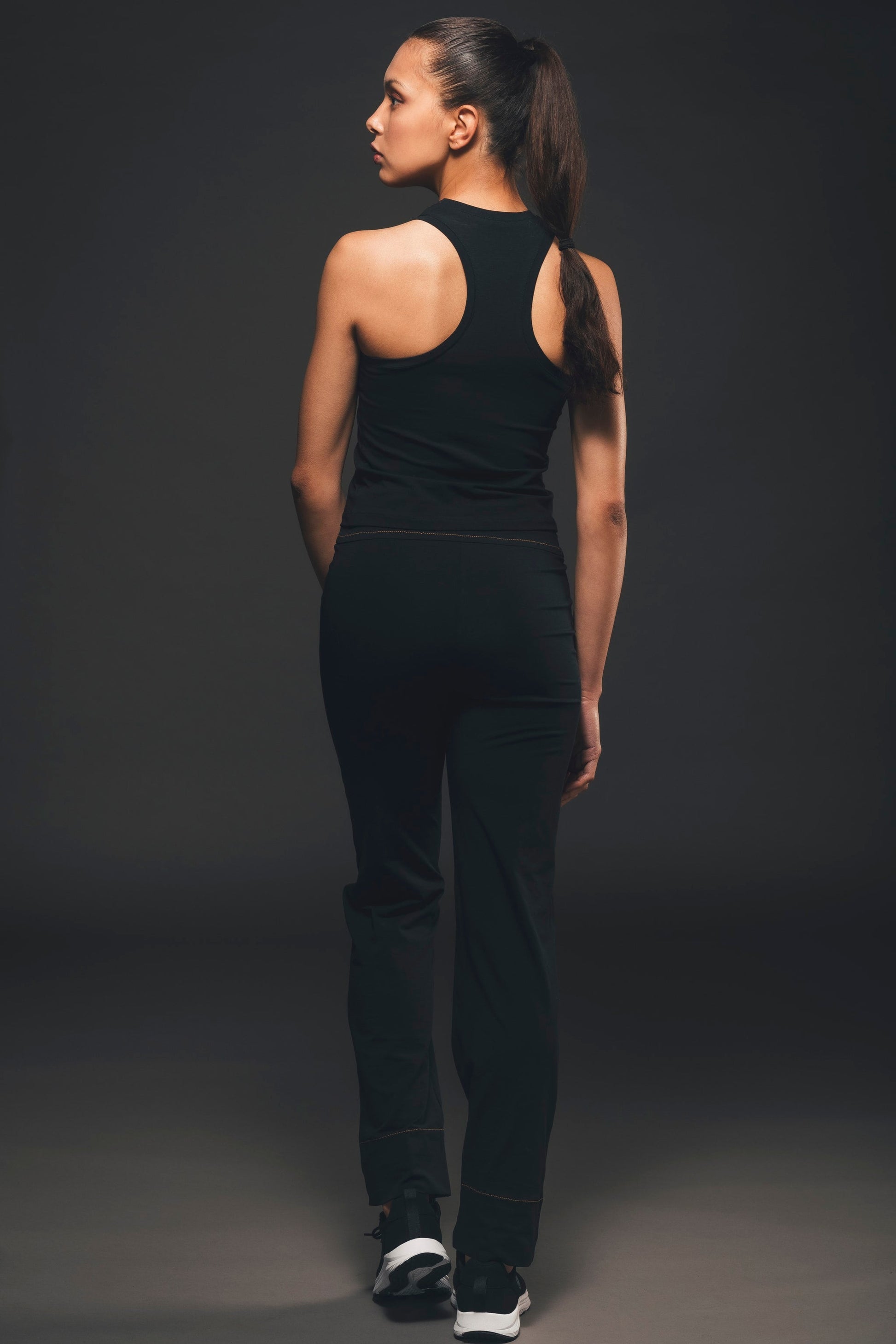 Image of back of straight leg black trousers made by Organique, a sustainable clothing brand. 