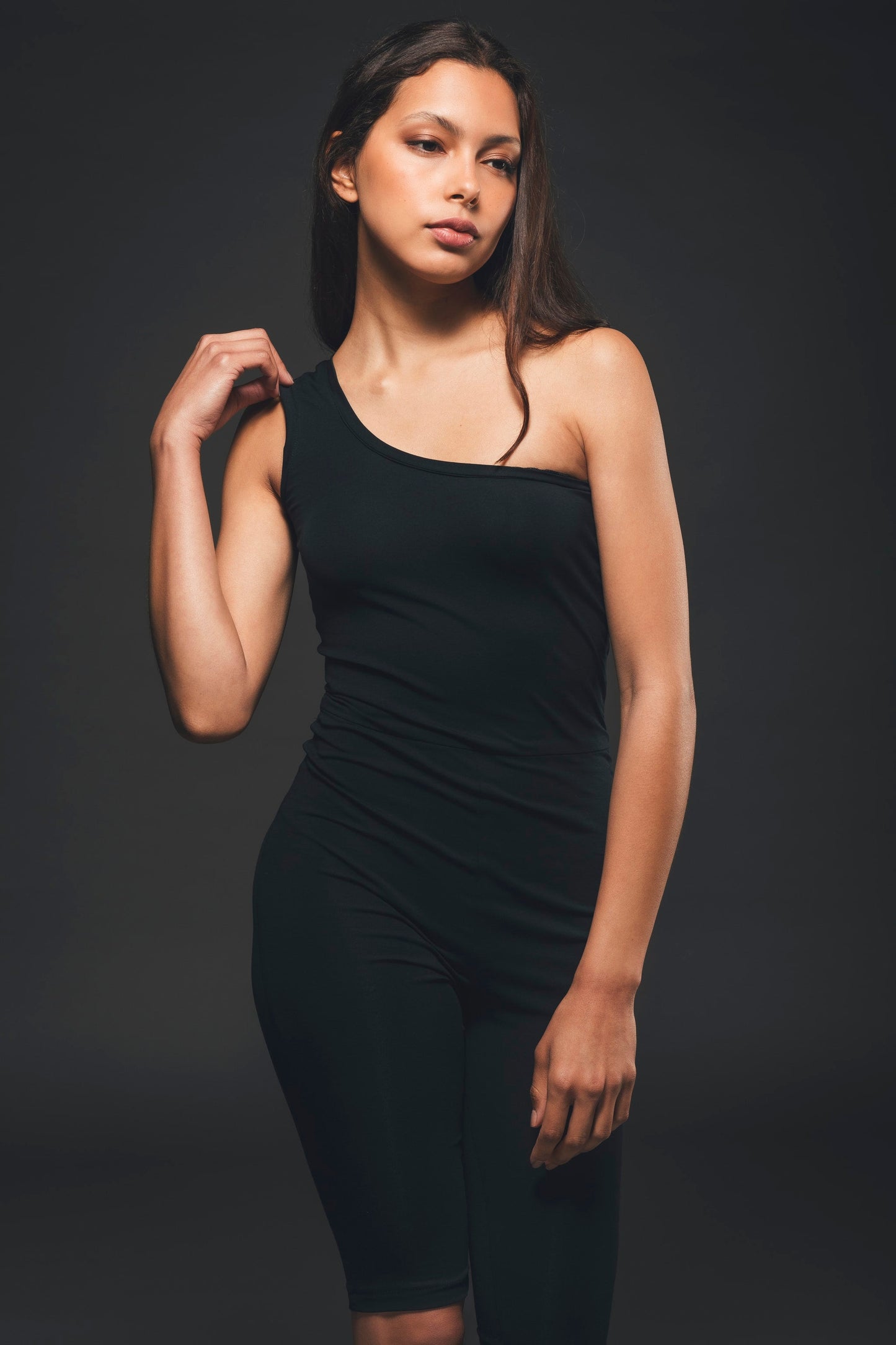 Image of black sustainable one shoulder jumpsuit made by Organique, a sustainable clothing brand.