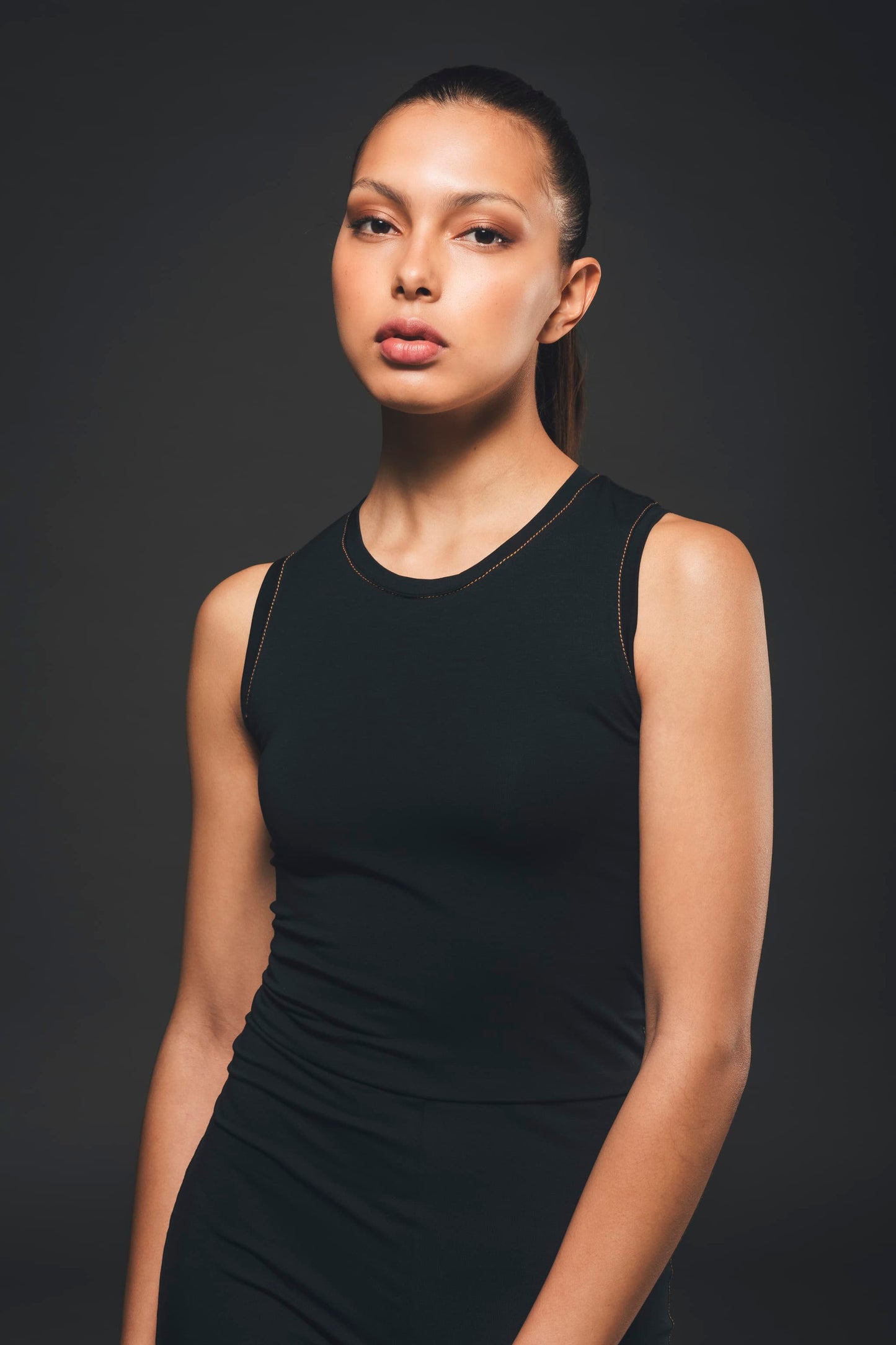 Image of top part of organic black stretch jumpsuit made by Organique, a sustainable clothing brand.