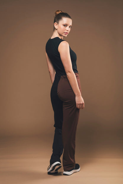 Image of back of vegan jumpsuit in black and brown made by Organique, a sustainable clothing brand.